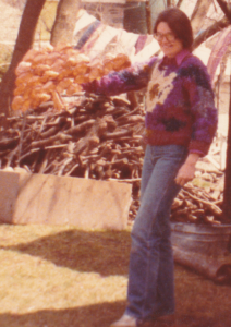 Cathy Callihan, showing a copper tree wall piece she created, 1983